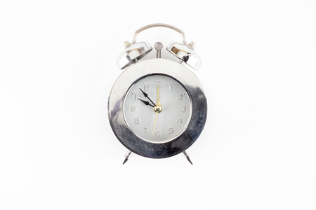 Front view of silver alarm clock isolated on white background.