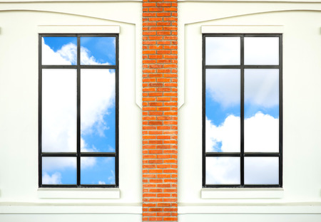 house window with brick post and reflection of nice blue sky.の写真素材