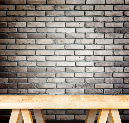 Empty wood modern table and grunge brown brick wall in background,Mock up template for display of your productの写真素材