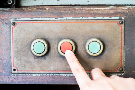 Finger press rustic control panel of old machine,grunge object.