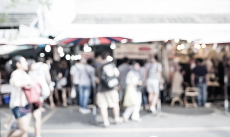 Blurred background  people shopping at market fair in sunny day, blur background with bokeh.の写真素材