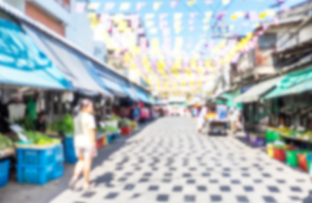 Blurred background : people shopping at market fair in sunny day, blur background with bokeh.の写真素材