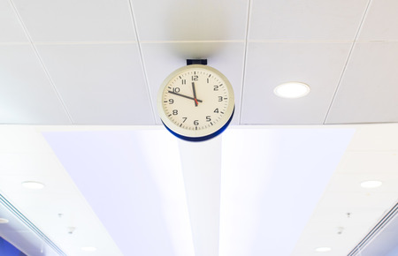 clock on ceiling at airport.
