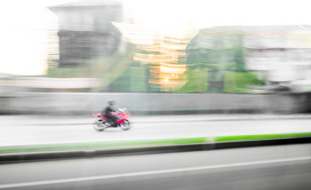 Motion blur background : red motorcycle running on road ,blurred backgroundの写真素材
