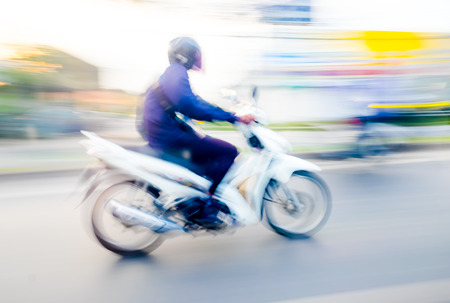 Motion blur background : red motorcycle running on road ,blurred backgroundの写真素材