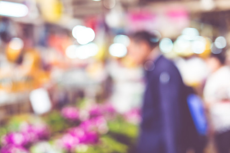Blurred background : people shopping at flower market fair, blur background with bokeh.の写真素材