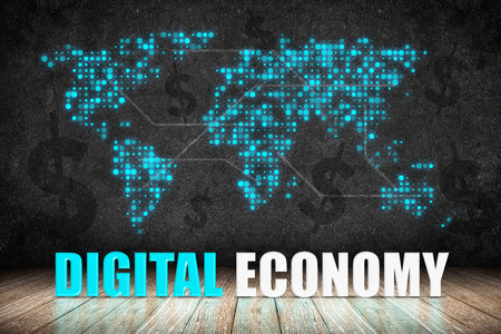 Digital Economy word on wood floor with dollar sign and dot world map on blackboard wall,Digital business concept.の写真素材
