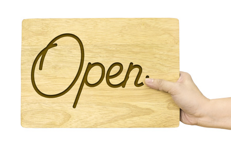 Hand holding wood plate with Open word isolated on white backgroundの写真素材