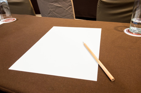white paper and pencil on table at seminar event.