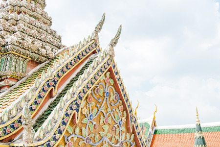 Close up Thai Temple with ornament art roof top at blue sky,Bangkok Thailand.