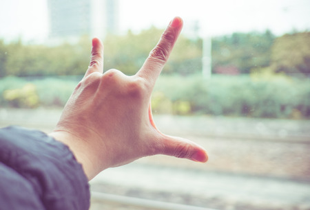 Love hand sign at train window, Love travel concept,Vintage filter.の写真素材