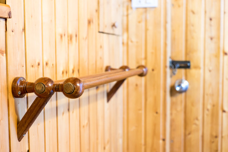 wood clothes line in wooden room.