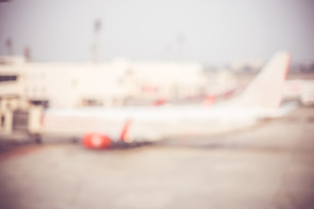 Blurred background : looking through terminal window to see airplane at airport.の写真素材