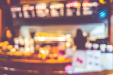 Blurred background : Vintage filter ,Coffee bar with barista at counter in cafe.の写真素材