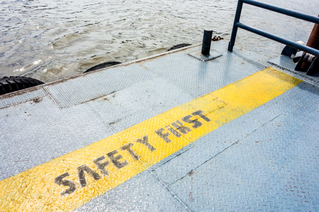 metal pier with safety first word near river.