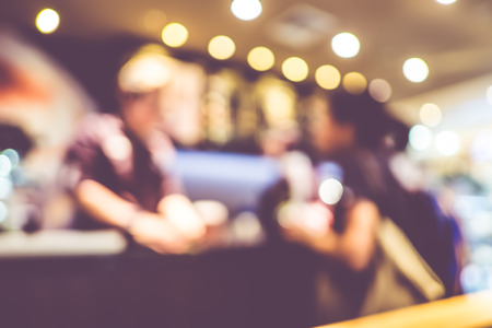 Blurred background : customer order beverage at coffee shop with bokeh light.の写真素材