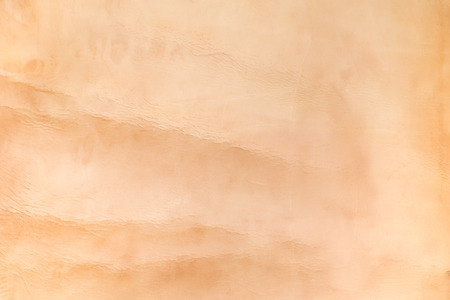 Close up nude color crumpled leather texture background.