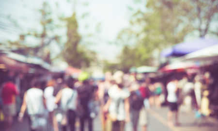 Blurred background : people shopping at market fair in sunny day, blur background with bokeh.の写真素材