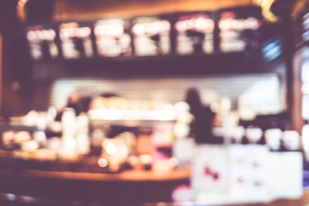 Blurred background : Vintage filter Customer at counter in Coffee shop blur background with bokeh.の写真素材