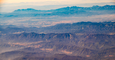 Aerial landscape view of mountain from window of airplane.