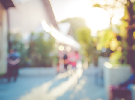 Blurred background : people shopping at market fair in sunny day, blur background with bokeh.の写真素材