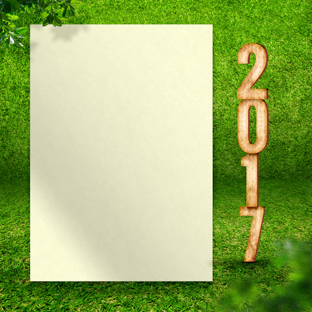 2017 new year and note paper on green grass room with blur leaf at foreground,Green Holiday concept,leave space for display your product.の写真素材