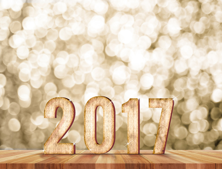 2017 year wood number in perspective room with sparkling bokeh wall and wooden plank floor,leave...