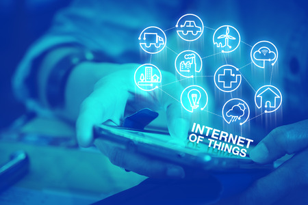 Close up woman using mobile phone with Internet of Things (IOT)  icon features, Digital lifestyle concept,Duotone color filtered.の写真素材