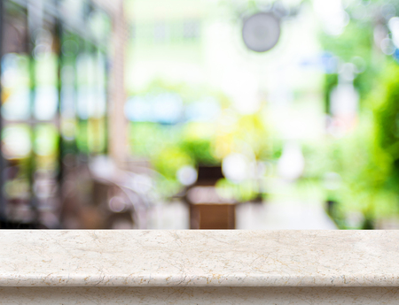 Empty luxury white marble table top with blurred cafe bokeh light as background. Mock up for display or montage of product,Business presentation.