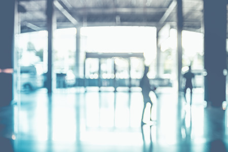 Blur background,people walking at corridor in convention hall, office building hall way background.の写真素材