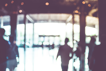 Blur background,people walking at corridor in convention hall, office building hall way background.の写真素材