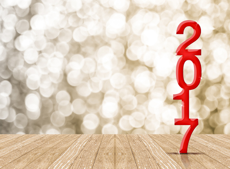 red 2017 year wood number in perspective room with sparkling bokeh wall and wooden plank floor,leave...