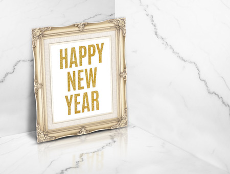 Happy new year word on vintage golden photo frame at white glossy marble corner studio room background,holiday greeting card.の写真素材