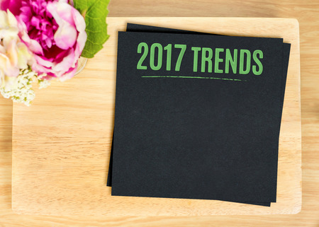 Top view of wooden plate with green 2017 trends on black menu and flower pot on table top,Mock up for adding your content for gourmet business.の写真素材