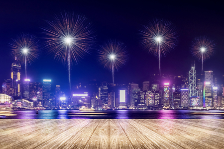 Empty wood plank floor with fireworks over cityscape at night background,Mock up template for display or montage of product for social media advertising,Celebration season.の写真素材