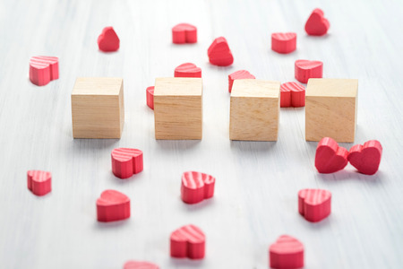 Stack of blank wood cube with group of mini red heart on white rustic table top,Mock up for adding your text or word,Love concept.の写真素材
