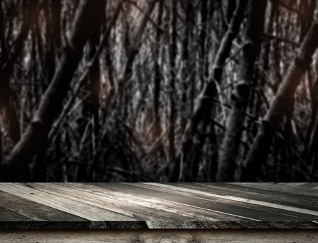Empty grunge plank wooden table top at spooky tree and full moon with blur dead tree,Halloween holiday concept,Template mock up for display or montage of productの写真素材