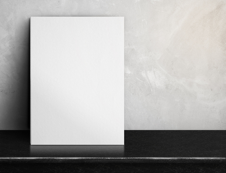 Blank White paper poster on black marble table at grey concrete wall,Template mock up for adding your design and leave space beside frame for adding more textの写真素材