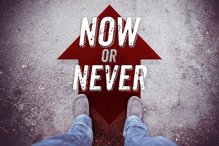 Inspiration quote ,Now or Never on aerial view of shoe on road with move forward red arrow ,Motivational typographic.の写真素材