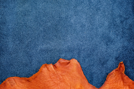 Close up orange rough edge and navy blue leather divide in two section, fashion texture background,fabric division.の写真素材