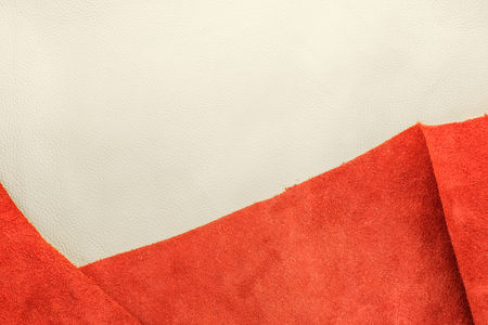 Close up white leather and suede orange leather divide two section, texture background,fabrics Division.の写真素材