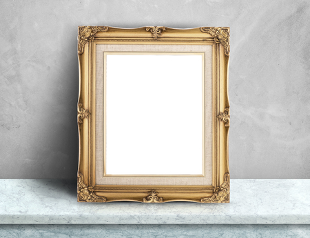 Blank Gold victorian picture frame on white marble table at grey concrete wall,Template mock up for adding your design and leave space beside frame for adding more textの写真素材