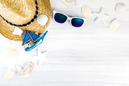 Summer Beach accessories (White sunglasses,starfish,straw hat,shell) on white plaster wood table top view,Summer vacation concept,Leave space for adding text.の写真素材