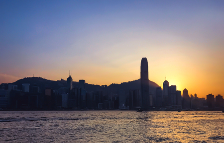 sillouette view of Hong kong city building with sea in sunset evening time,skyline,cityscape...