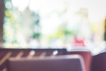 Blurred background of coffee shop or cafe restaurant with bokeh light.