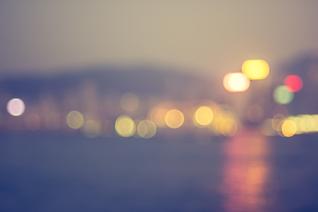 Blurred abstract background of cityscape at sea harbour hong kong at night time,urban life,vintage filter.の写真素材