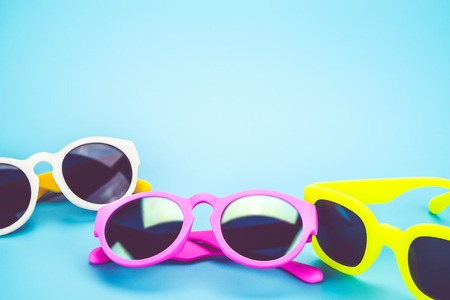 group of colorful sunglasses at light blue studio background.Summer Holiday concept.leave space for adding text.の写真素材