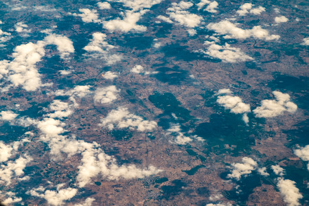 Aerial view of airplane window looking down to land ,Nature background.の写真素材