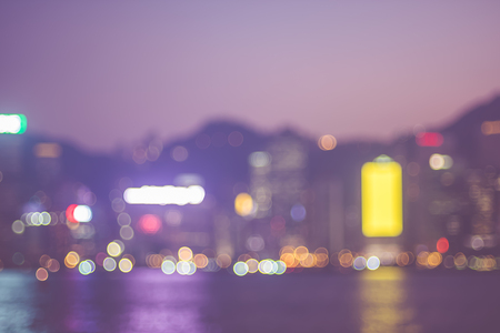Blurred abstract background of cityscape at sea harbour hong kong at night time,urban life,vintage filter.の写真素材