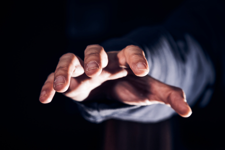 Close up hand try to threatening at personal in dark tone,online personal data security concept.の写真素材